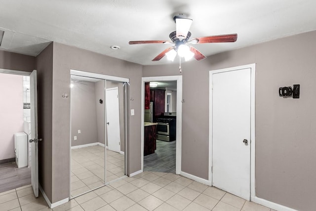 715 S Barnett Ave, Dallas, TX 75211 - unfurnished bedroom with baseboards, light tile patterned floors, and ceiling fan
