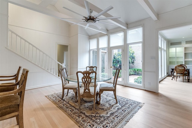 5865 Farquhar Ln, Dallas, TX 75209 - dining area featuring light wood-style flooring, beam ceiling, stairs, ceiling fan, and a decorative wall