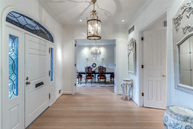 5865 Farquhar Ln, Dallas, TX 75209 - foyer with a chandelier, light wood-style floors, ornamental molding, baseboards, and recessed lighting