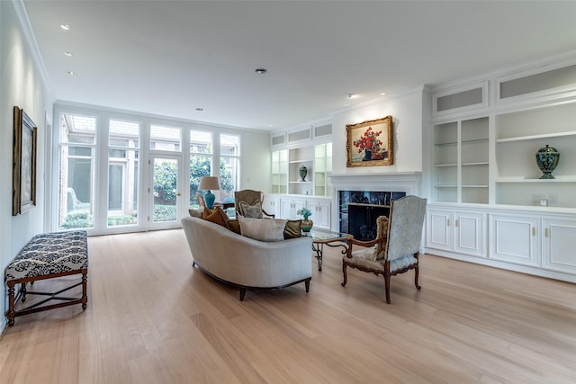 5865 Farquhar Ln, Dallas, TX 75209 - living room with ornamental molding, light wood-type flooring, a fireplace, built in features, and recessed lighting