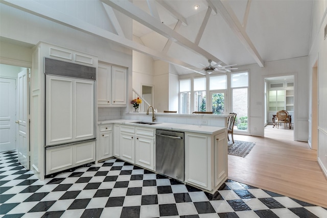 5865 Farquhar Ln, Dallas, TX 75209 - kitchen featuring stainless steel dishwasher, a peninsula, light countertops, a sink, and beam ceiling