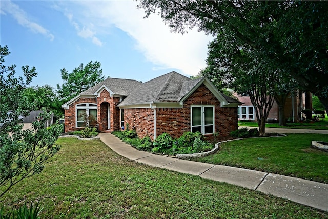 5133 Sunscape Ln S, Fort Worth, TX 76123 - view of front facade with brick siding, a front yard, and roof with shingles