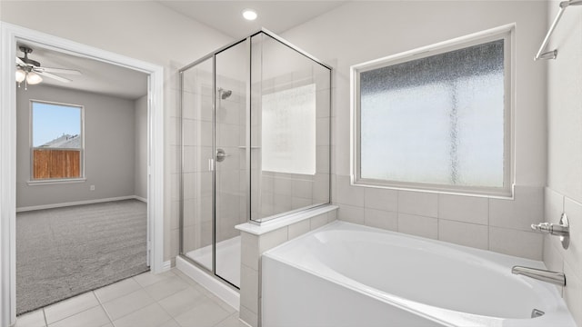 1109 Rushing Ct, Aubrey, TX 76227 - full bathroom featuring a shower stall, a garden tub, ceiling fan, tile patterned floors, and baseboards