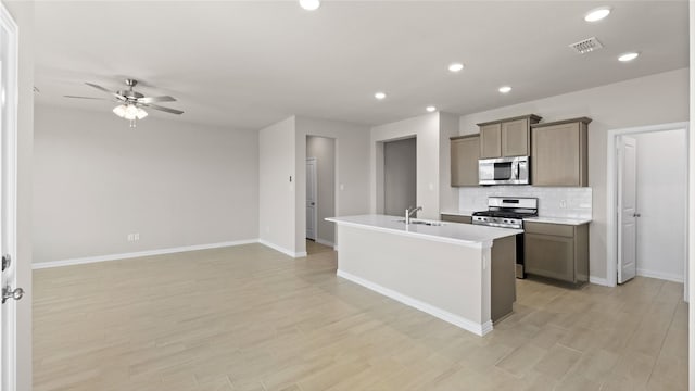 1109 Rushing Ct, Aubrey, TX 76227 - kitchen featuring stainless steel appliances, tasteful backsplash, a ceiling fan, recessed lighting, and baseboards
