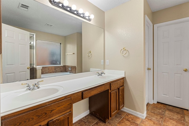4953 Sunset Ridge Dr, Fort Worth, TX 76123 - bathroom with a garden tub, double vanity, baseboards, and a textured ceiling