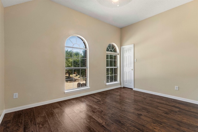 4953 Sunset Ridge Dr, Fort Worth, TX 76123 - spare room with dark wood-type flooring, baseboards, and vaulted ceiling