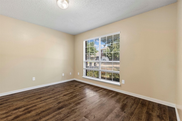4953 Sunset Ridge Dr, Fort Worth, TX 76123 - spare room with baseboards, dark wood-type flooring, and a textured ceiling