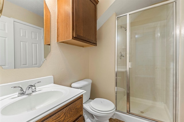 4953 Sunset Ridge Dr, Fort Worth, TX 76123 - bathroom featuring a stall shower, toilet, vanity, and a textured wall