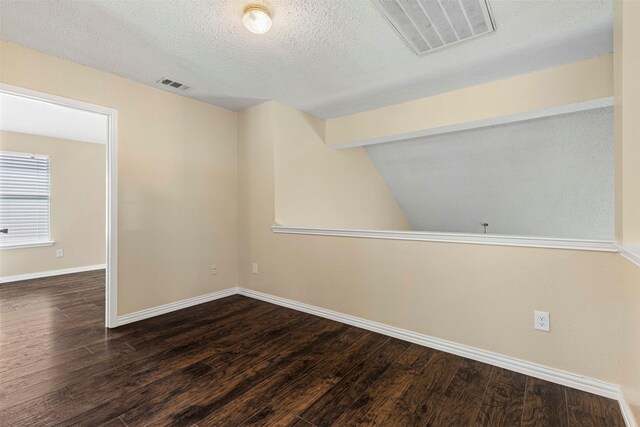 4953 Sunset Ridge Dr, Fort Worth, TX 76123 - empty room featuring wood finished floors, baseboards, a textured ceiling, and lofted ceiling