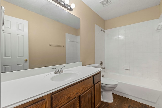 4953 Sunset Ridge Dr, Fort Worth, TX 76123 - bathroom with toilet, vanity, wood finished floors, and bathing tub / shower combination
