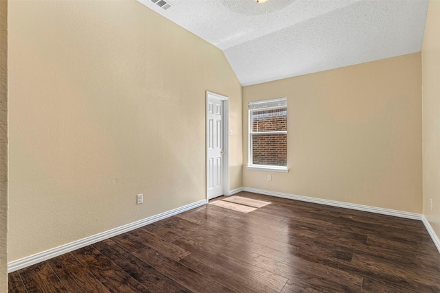 4953 Sunset Ridge Dr, Fort Worth, TX 76123 - unfurnished room with vaulted ceiling, dark wood-style flooring, baseboards, and a textured ceiling
