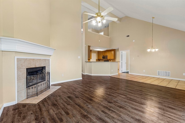 4953 Sunset Ridge Dr, Fort Worth, TX 76123 - unfurnished living room featuring high vaulted ceiling, ceiling fan, wood finished floors, a fireplace, and beam ceiling