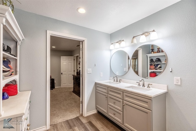 426 Brown Ave, Tuscola, TX 79562 - bathroom with wood finished floors, double vanity, and baseboards