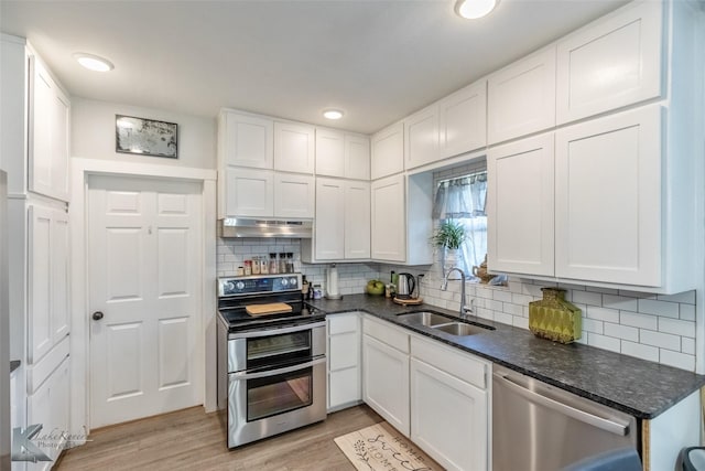 426 Brown Ave, Tuscola, TX 79562 - kitchen with appliances with stainless steel finishes, a sink, under cabinet range hood, white cabinets, and recessed lighting