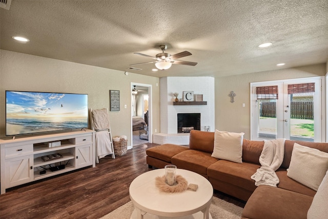 3701 Nocona Dr, Granbury, TX 76049 - living room featuring ceiling fan, a textured ceiling, dark wood finished floors, recessed lighting, and a fireplace