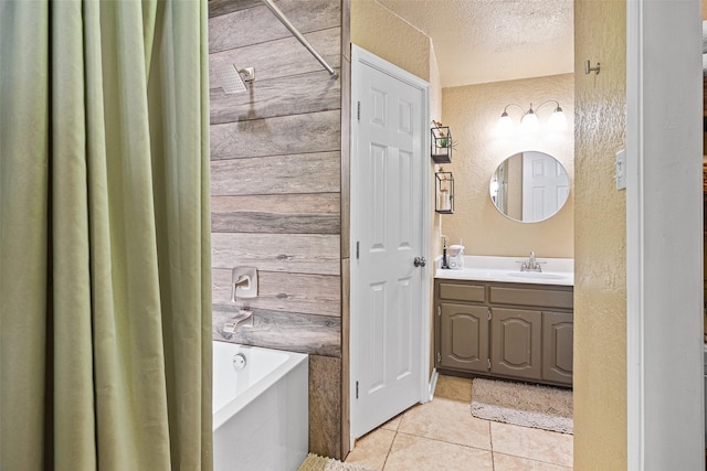 3701 Nocona Dr, Granbury, TX 76049 - full bathroom with a tub, vanity, tile patterned floors, a textured ceiling, and a textured wall