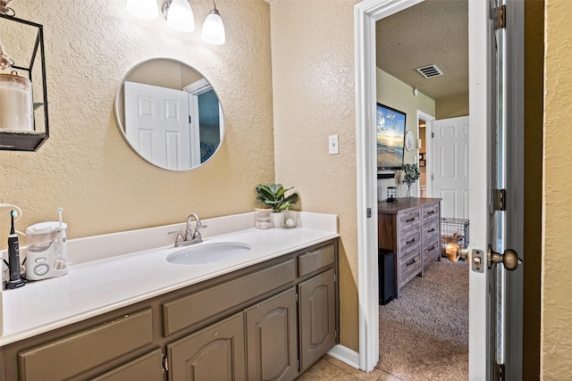 3701 Nocona Dr, Granbury, TX 76049 - bathroom featuring a textured wall, vanity, tile patterned floors, and a textured ceiling