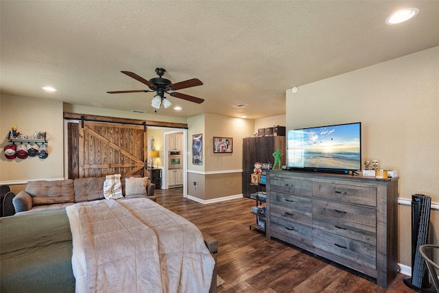 3701 Nocona Dr, Granbury, TX 76049 - bedroom with a barn door, dark wood-style floors, baseboards, recessed lighting, and ceiling fan