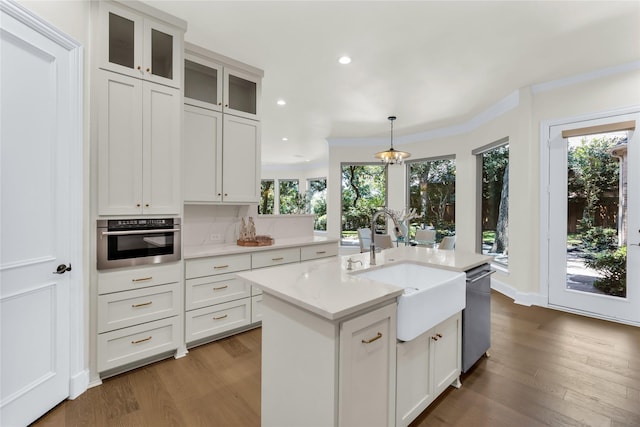 6628 Castle Pines Dr, Plano, TX 75093 - kitchen with a sink, appliances with stainless steel finishes, wood finished floors, healthy amount of natural light, and recessed lighting