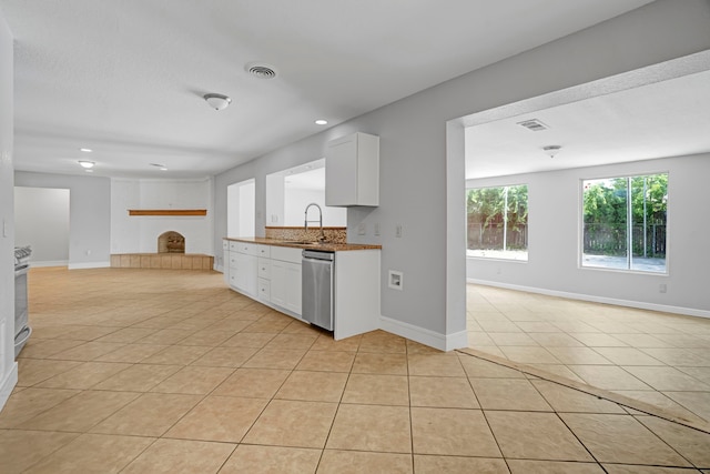 229 Cotillion Rd, Fort Worth, TX 76134 - kitchen featuring open floor plan, stainless steel dishwasher, a brick fireplace, a sink, and recessed lighting
