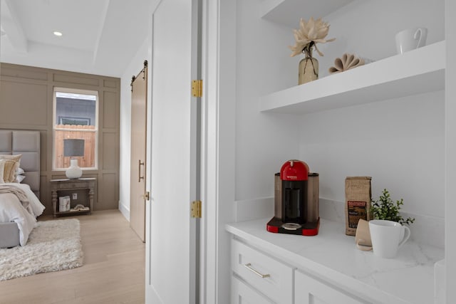 317 Rusk St, Roanoke, TX 76262 - bedroom featuring a barn door, light wood-type flooring, and recessed lighting