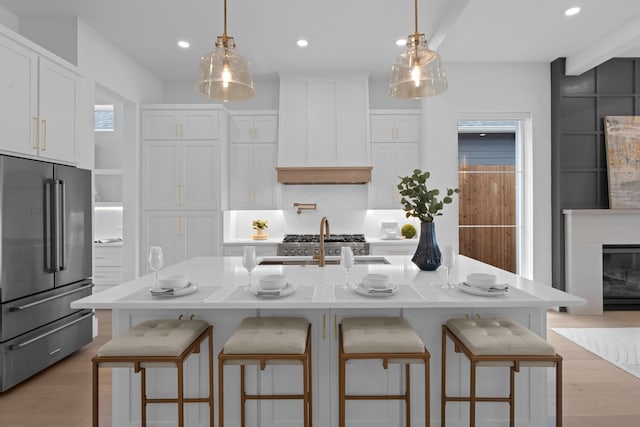 317 Rusk St, Roanoke, TX 76262 - kitchen featuring high end fridge, premium range hood, light wood finished floors, white cabinets, and recessed lighting