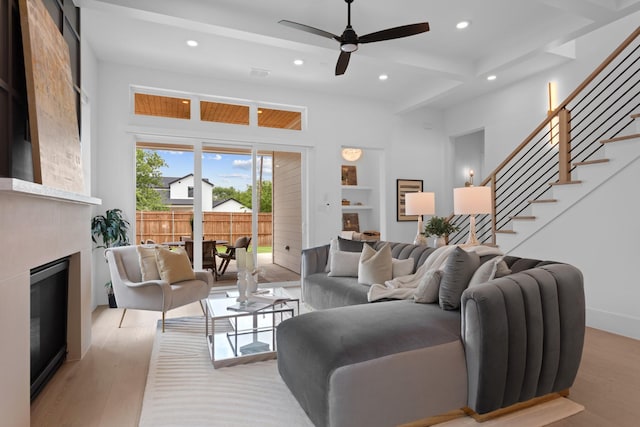 317 Rusk St, Roanoke, TX 76262 - living room with a glass covered fireplace, recessed lighting, stairway, wood finished floors, and a ceiling fan