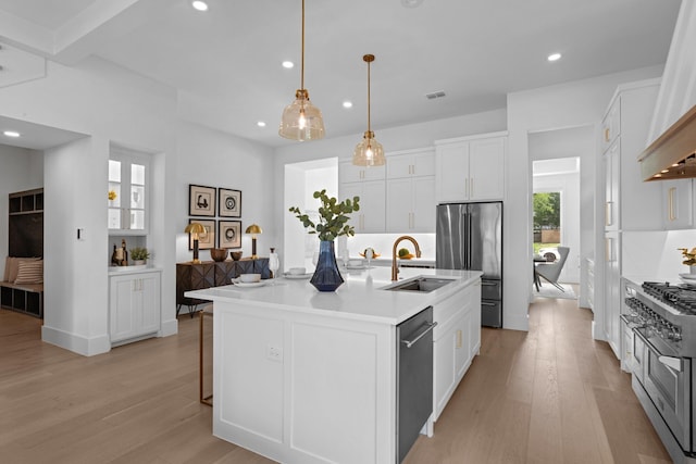 317 Rusk St, Roanoke, TX 76262 - kitchen featuring high quality appliances, wall chimney range hood, light wood finished floors, recessed lighting, and white cabinets