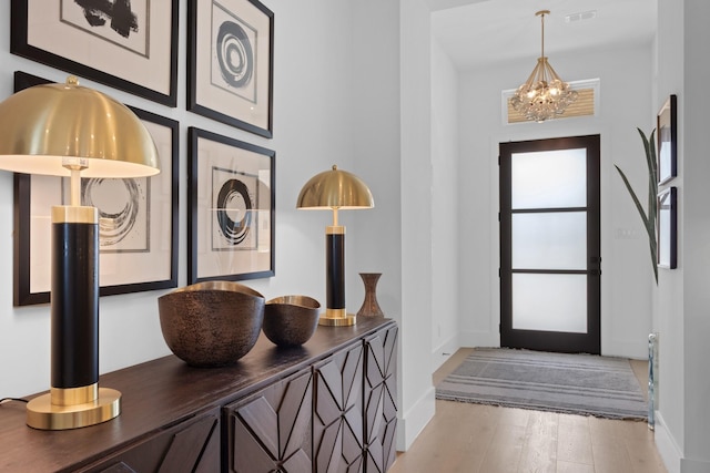 317 Rusk St, Roanoke, TX 76262 - entryway featuring a chandelier and wood finished floors