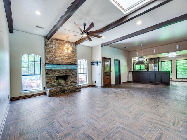 18636 Crownover Ct, Dallas, TX 75252 - unfurnished living room with baseboards, beamed ceiling, ceiling fan, a stone fireplace, and a skylight