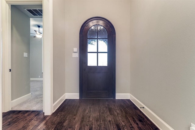 3204 Stonefield, The Colony, TX 75056 - foyer entrance featuring dark wood-style floors, ceiling fan, and arched walkways