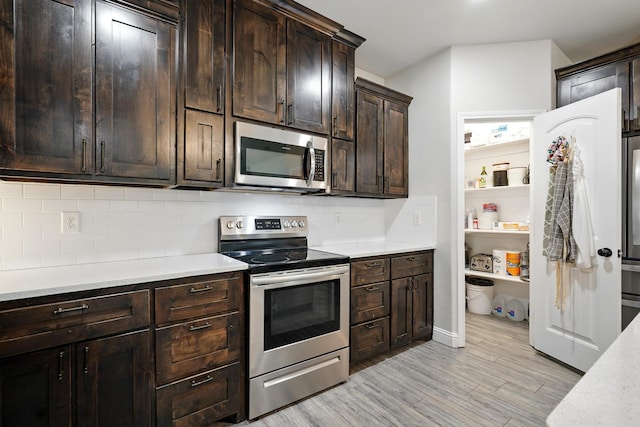 120 Oak Hill Rd, Tuscola, TX 79562 - kitchen with stainless steel appliances, decorative backsplash, light wood-type flooring, and dark brown cabinets