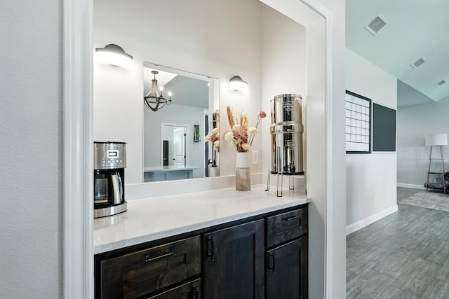 120 Oak Hill Rd, Tuscola, TX 79562 - bathroom with a chandelier, vanity, baseboards, and wood finished floors