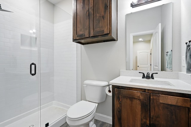 120 Oak Hill Rd, Tuscola, TX 79562 - bathroom with toilet, a stall shower, vanity, baseboards, and wood finished floors