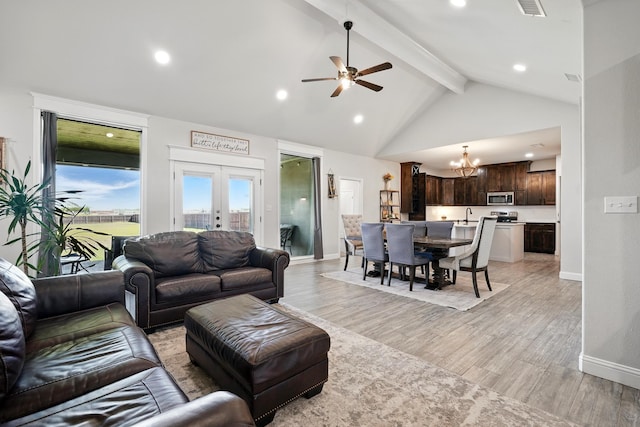 120 Oak Hill Rd, Tuscola, TX 79562 - living area featuring a chandelier, beamed ceiling, light wood-type flooring, a ceiling fan, and baseboards