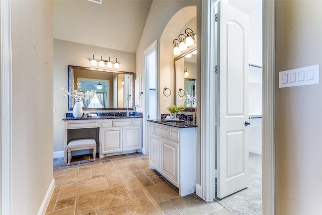2028 Sterling Trace Dr, Keller, TX 76248 - bathroom with vanity, stone tile floors, baseboards, and vaulted ceiling