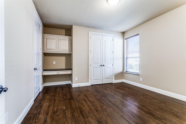 2028 Sterling Trace Dr, Keller, TX 76248 - unfurnished bedroom with dark wood-type flooring, baseboards, and a closet