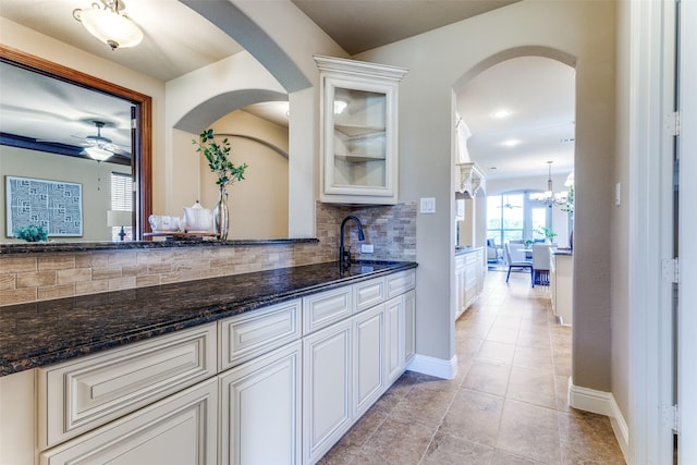 2028 Sterling Trace Dr, Keller, TX 76248 - bar featuring tasteful backsplash, light tile patterned floors, baseboards, and arched walkways