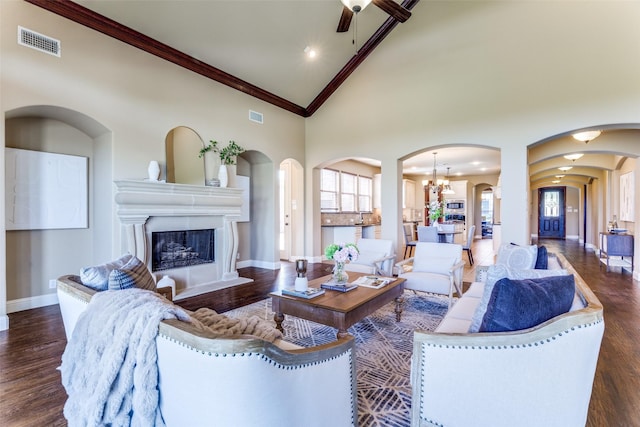 2028 Sterling Trace Dr, Keller, TX 76248 - living room featuring arched walkways, baseboards, wood finished floors, crown molding, and high vaulted ceiling