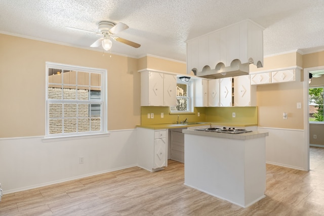 2111 Chippendale Dr, Mckinney, TX 75071 - kitchen with a ceiling fan, a textured ceiling, light countertops, white cabinetry, and a center island
