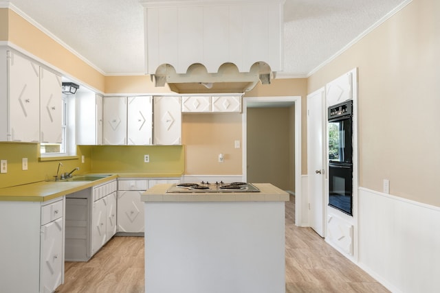 2111 Chippendale Dr, Mckinney, TX 75071 - kitchen with a sink, light wood-style floors, cooktop, a center island, and a textured ceiling