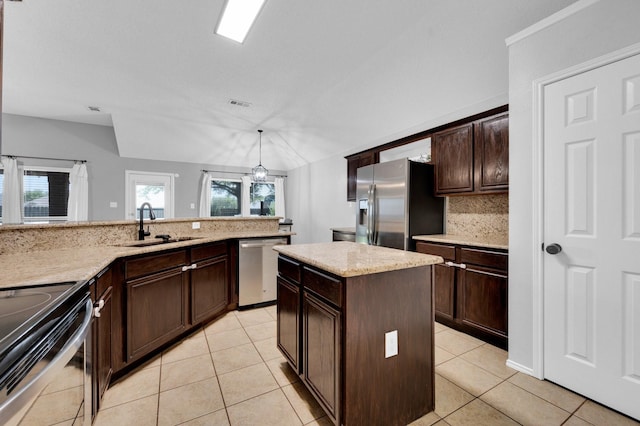 3214 Eagle Ln, Midlothian, TX 76065 - kitchen with stainless steel appliances, a sink, light tile patterned floors, and dark brown cabinetry