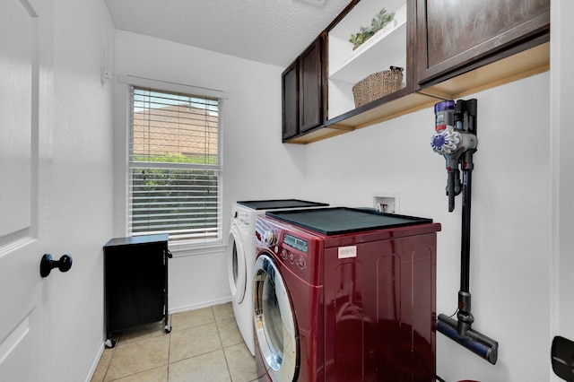 3214 Eagle Ln, Midlothian, TX 76065 - washroom featuring cabinet space, washer and dryer, healthy amount of natural light, baseboards, and a textured ceiling