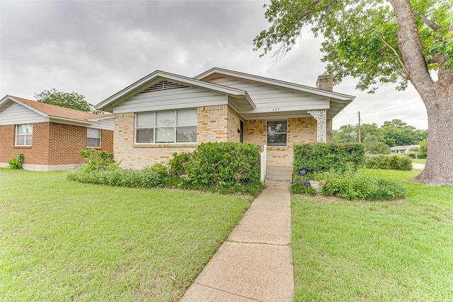 307 E Rio Grande St, Garland, TX 75041 - view of front facade featuring a chimney, brick siding, a front yard, and a porch