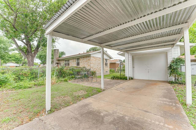 307 E Rio Grande St, Garland, TX 75041 - view of patio featuring a garage and a carport