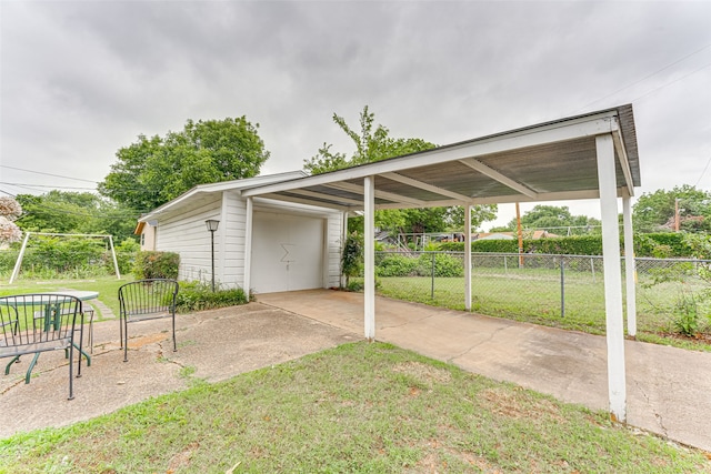 307 E Rio Grande St, Garland, TX 75041 - view of patio with a detached garage and an outbuilding