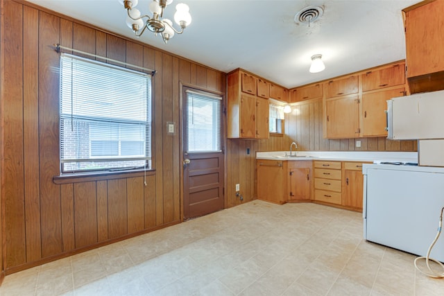 307 E Rio Grande St, Garland, TX 75041 - kitchen featuring stove, a chandelier, light countertops, a sink, and light flooring