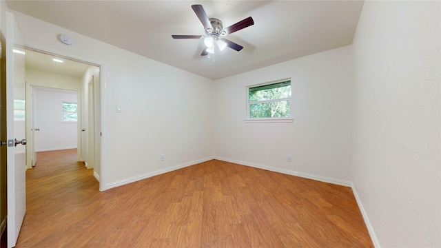 2350 Ravenwood Dr, Grand Prairie, TX 75050 - spare room featuring baseboards, light wood-style flooring, a ceiling fan, and a smoke detector