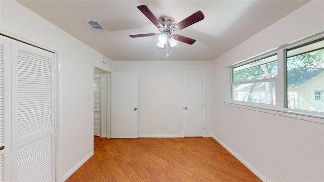2350 Ravenwood Dr, Grand Prairie, TX 75050 - unfurnished bedroom featuring light wood-style floors, baseboards, a closet, and ceiling fan