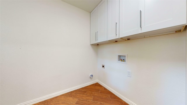 2350 Ravenwood Dr, Grand Prairie, TX 75050 - washroom featuring cabinet space, electric dryer hookup, baseboards, hookup for a washing machine, and wood finished floors